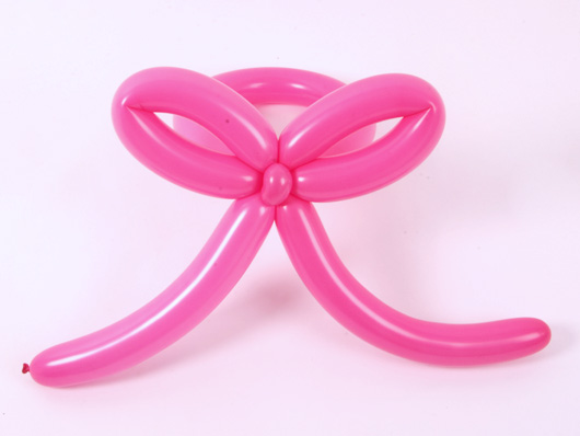  Соединяем оба элемента из розовых воздушных шаров для моделирования и получаем бантик для букета из воздушных шариков.